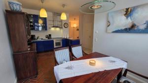 a kitchen and dining room with a wooden table at Altstadt Zauber in Waren