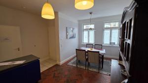 a kitchen with a table and chairs in a room at Altstadt Zauber in Waren +8 photos