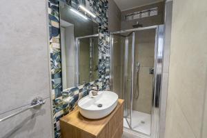 a bathroom with a sink and a shower at Barrio La Suite del Borgo Bacoli in Bacoli +15 photos