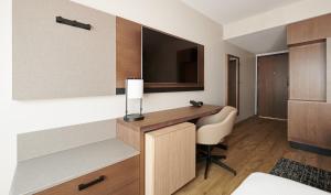 a hotel room with a desk and a television at Hyatt Place Waco/Downtown in Waco +5 photos