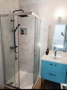 a bathroom with a glass shower and a sink at "Aux Portes de CDG" in Thieux +84 photos