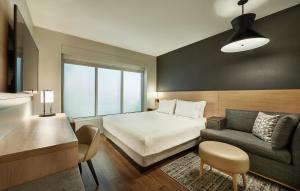 a hotel room with a bed and a couch at Hyatt Place Waco/Downtown in Waco