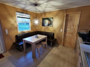 a dining room with a table and chairs and a window at Bungalow Seedorf 7 in Basedow