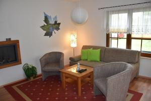 a living room with a couch and two chairs and a table at Ferienwohnung Seedorf in Basedow