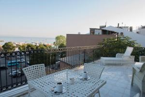 a patio with a table and chairs on a balcony at Rodosto Hotel in Tekirdağ