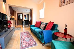 a living room with a blue couch and a table at Radnor Rest in Folkestone