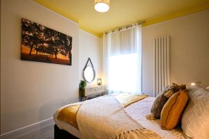a bedroom with a bed with a mirror and a window at Radnor Rest in Folkestone
