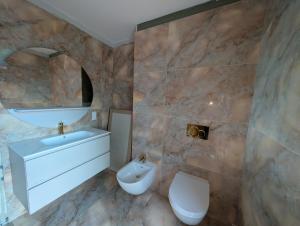 a bathroom with a sink and a toilet at Waldresidenz Lutz in Bad Lippspringe