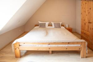 a bedroom with a wooden bed in a attic at Am Müritzer Hafen App 4 in Waren