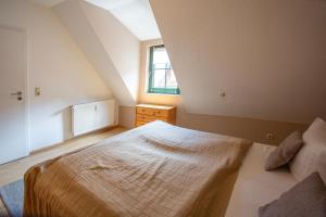 a bedroom with a bed and a window at Am Müritzer Hafen App 4 in Waren +2 photos