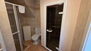 a bathroom with a toilet and a glass shower at Altstadt Loft in Waren