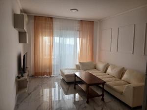 a living room with a couch and a coffee table at Pogled na more in Pečurice