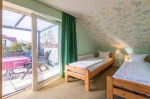 a bedroom with a bed and a sliding glass door at Ferienwohnung Sonnendeck in Klink