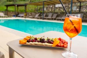 a tray of food and a drink next to a pool at Le Querce Farmhouse in Agropoli