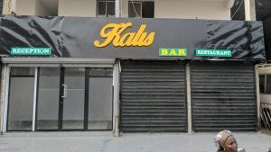 a person walking in front of a bar at Kalis Hotel in Douala