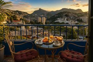 a table with a plate of food on a balcony at Panorama Inn in Rio de Janeiro