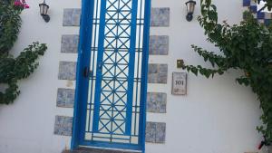 a blue door on the side of a wall at روشيلا in Al Majma'ah +3 photos