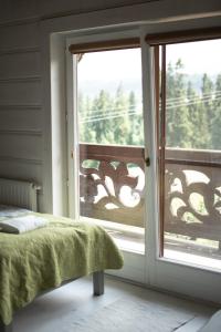 a bedroom with a bed and a window with a view at Alpejska Szarotka in Nowe Bystre