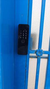 a blue door with a remote control on it at روشيلا in Al Majma'ah
