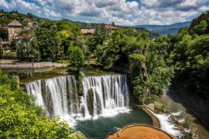 a waterfall in the middle of a river at JAJCE Historic House in Jajce
