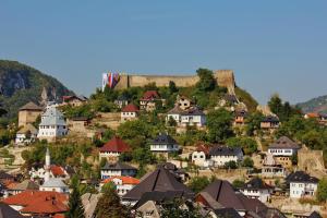 a town on a hill with houses and a castle at JAJCE Historic House in Jajce
