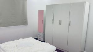 a bedroom with white cabinets and a bed at Mountain View House- بيت إطلالة الجبل in Ajloun