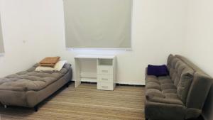 a living room with two couches and a table at Mountain View House- بيت إطلالة الجبل in Ajloun