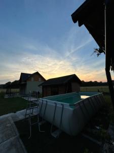 a small pool in a yard with a house at Noclegi u Dąbka 2 in Głębokie