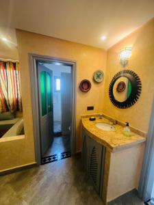 a bathroom with a sink and a mirror at Zakar Apartments & Terrace in Mirleft +61 photos