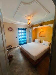 a bedroom with a large white bed in a room at Zakar Apartments & Terrace in Mirleft