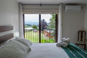 a bedroom with a bed with towels on it at Centro Turistico Lafquintue in Ranco +32 photos