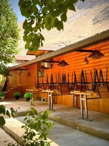 a building with tables and chairs in front of it at 2149 Hotel in Khorog