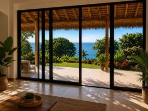 an open living room with a view of the ocean at ITAMPOLO Suites & Lodges in Nosy Be