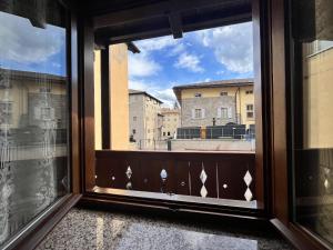 an open window with a view of a city at Casa Adry in Cles