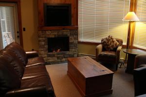 a living room with a couch and a fireplace at Timberline Lodges by Fernie Lodging Co in Fernie