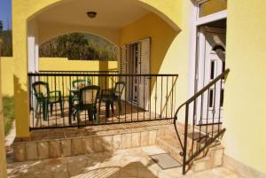 a balcony of a house with chairs and a table at Apartments Villa-G Lustica in Tivat