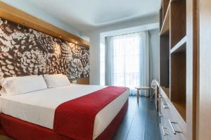 a bedroom with a bed and a wall with flowers at VM Princep in Andorra la Vella +18 photos
