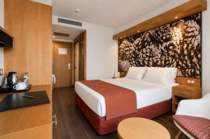 a hotel room with a bed and a desk at VM Princep in Andorra la Vella