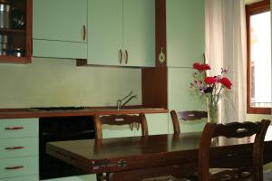 a kitchen with a table and a vase of flowers at A Casa di Nunzi in Tropea