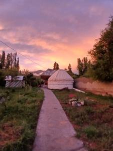 a field with a tent and a path at Mary's Home in Korumdy