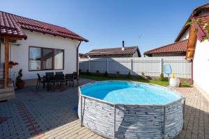 a swimming pool in the backyard of a house at Mountain View House Brasov in Braşov