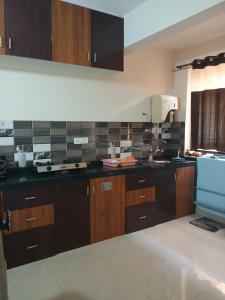 a kitchen with wooden cabinets and a white appliance at Serenity Casa ll in Varca