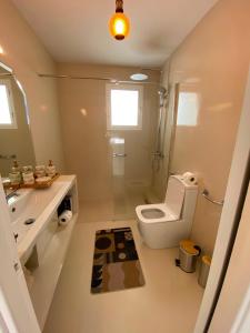 a white bathroom with a toilet and a sink at Marbella Sunseat apartment in Marbella +12 photos