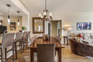 a dining room and living room with a table and chairs at Walk to Beaver Creek Village - 2BR Condo with Chairlift Views, Pool & Hot Tub in Beaver Creek +16 photos