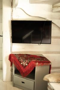 a table with a red cloth on top of a wall at Alpejska Szarotka in Nowe Bystre
