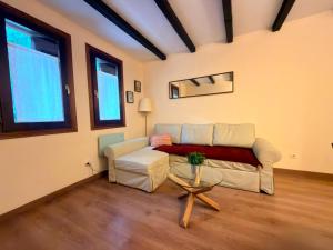 a living room with a couch and a table at El Boj in Canfranc