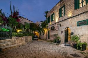 an alley in an old town at night at Medieval Inn in Rhodes Town