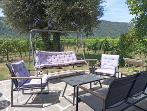 a gazebo with a couch and two chairs and a table at Il Rifugio in Franciacorta in Erbusco