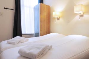 Postel nebo postele na pokoji v ubytování Hotel Carillon