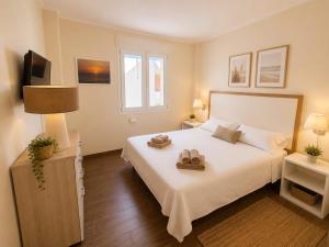 a bedroom with a bed with two towels on it at Felicity Residence in Gallipoli +61 photos
